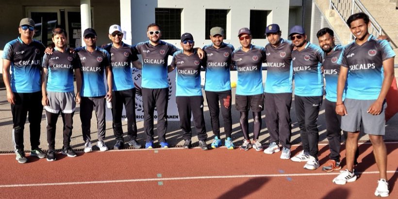 The squad lined up along a running track in blue and grey kit