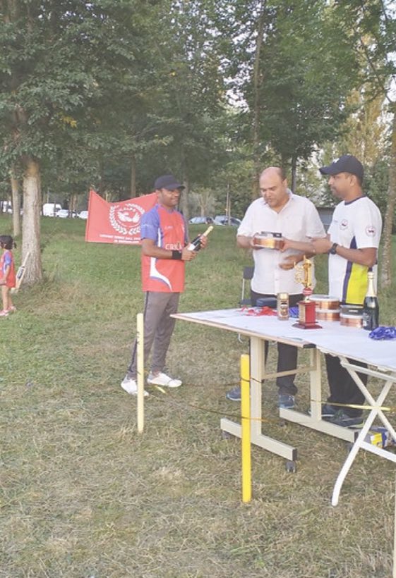 Two members setting up the presentation table, club flag tied behind them